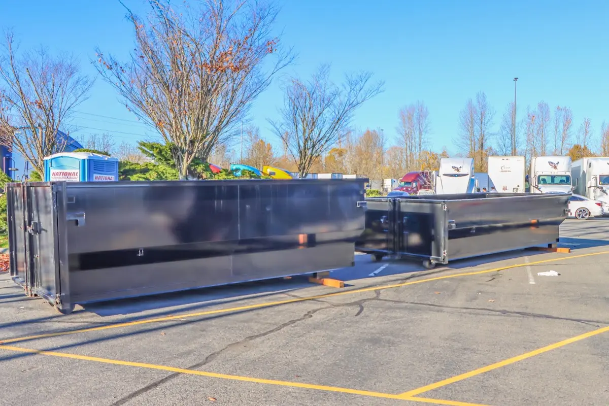 Professional dumpster rental service with roll-off container on residential driveway in Ormond-by-the-Sea